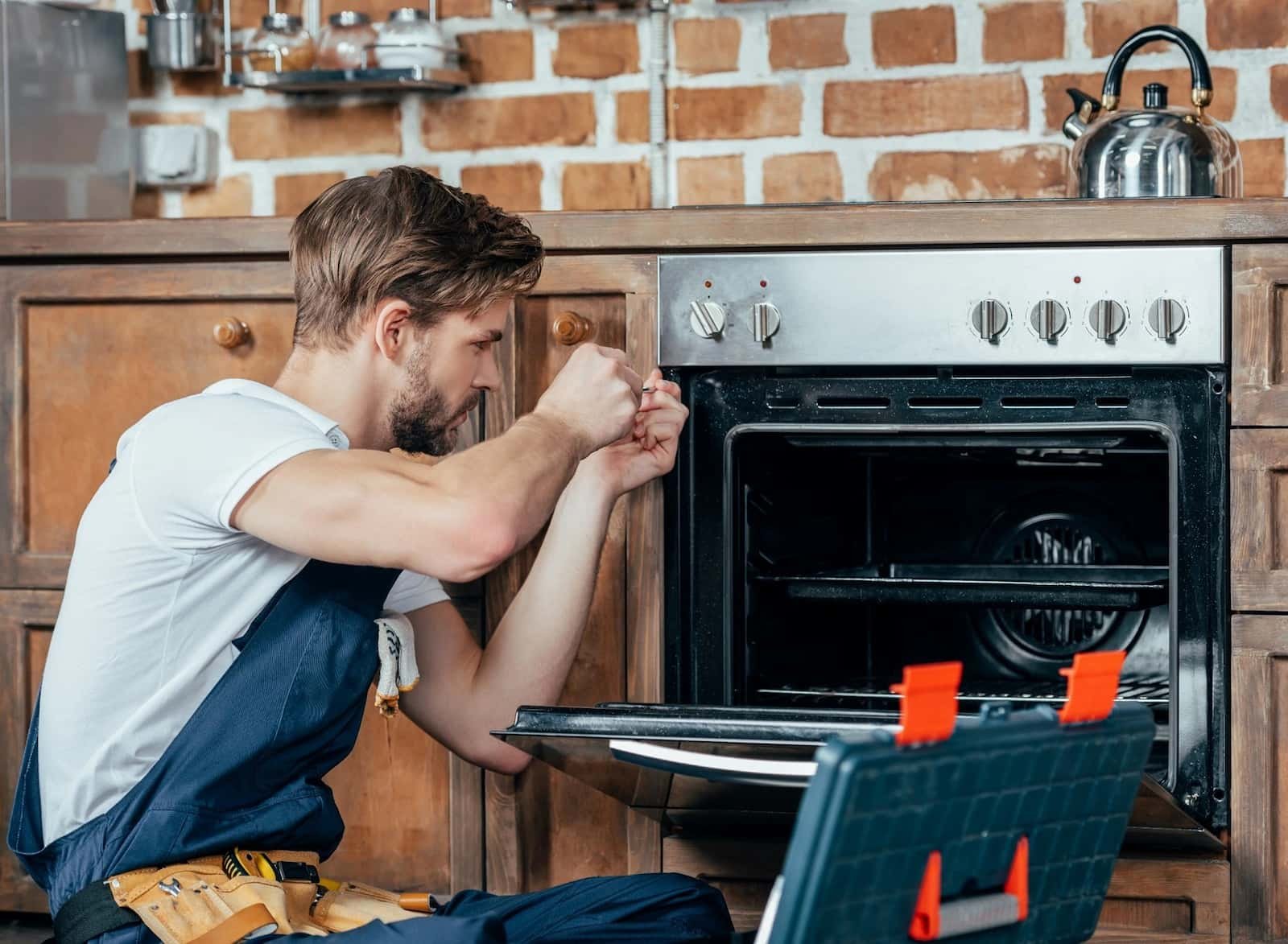 Appliance repair technician servicing a kitchen appliance in Tampa Bay